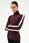 A person wearing the SPLITS59 Jackson Rib Full Length Turtleneck in Dark Cherry/Creme—a soft modal blend maroon turtleneck featuring white stripes on the sleeves—stands with arms crossed against a plain white background.