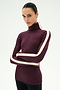 A person wearing the SPLITS59 Jackson Rib Full Length Turtleneck in Dark Cherry/Creme—a soft modal blend maroon turtleneck featuring white stripes on the sleeves—stands with arms crossed against a plain white background.
