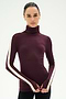 A woman wearing the SPLITS59 Jackson Rib Full Length Turtleneck in Dark Cherry/Creme—a soft modal blend with white stripes down the sleeves—stands against a plain light background.