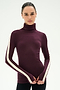 A woman wearing the SPLITS59 Jackson Rib Full Length Turtleneck in Dark Cherry/Creme—a soft modal blend with white stripes down the sleeves—stands against a plain light background.