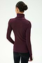 A person with their hair in a bun is shown from the back, wearing the SPLITS59 Jackson Rib Full Length Turtleneck in Dark Cherry/Creme—a comfortable modal blend top with spandex for added stretch, featuring a white stripe along the sleeve—against a plain background.
