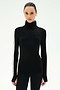 Wearing the SPLITS59 Jackson Rib Full Length Turtleneck in Black/Creme—a black sweater featuring creme stripes along the sleeves—a person stands facing forward against a plain white background.