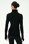 A person with dark hair in a bun is seen from behind, wearing the SPLITS59 Jackson Rib Full Length Turtleneck in Black/Creme and black pants, standing against a plain white background.