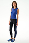 Woman wearing the SPLITS59 Nikki Jersey Tank - Cobalt, black spandex leggings with a blue stripe, and blue athletic shoes against a white background.