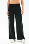 A person wearing SPLITS59’s Alex Airweight Cargo Pant in black, featuring side pockets and soft Airweight fabric, paired with white sneakers and standing against a plain light background.