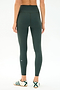 Person faces away, wearing SPLITS59 Airweight Rib High Waist 7/8 leggings in Military and white sneakers with green detail, against a plain light background.