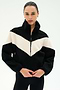 A person wearing the SPLITS59 Lottie Chevron Sherpa Full Zip Jacket in Black/Creme, made from 100% polyester, stands against a plain light background.