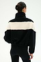 A person with dark hair in a bun is seen from the back against a plain light background, wearing the SPLITS59 Lottie Chevron Sherpa Full Zip Jacket in Black/Creme—crafted from soft 100% polyester—and black leggings.