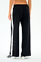 Model wears the SPLITS59 Willow Airweight Wide Leg pants in Black/White with white sneakers, shown from the back on a plain background—ideal for Pilates or casual outings.
