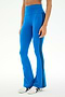 A person wearing the SPLITS59 Raquel High Waist Supplex Flare leggings in Classic Blue/Indigo, featuring black side stripes and white sneakers, stands against a plain background. These high-rise workout pants offer 4-way stretch for ultimate comfort and ease of movement.