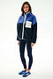 A woman stands in the SPLITS59 Skylar Sherpa Jacket - Indigo/Cobalt, featuring a white pocket, navy leggings, and blue sneakers against a white background.