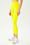 Front view of model wearing bright yellow high waist  leggings and white shoes
