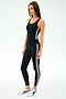 Wearing the SPLITS59 Ella High Waist Airweight 7/8 leggings in Black/White with white sneakers, a person stands against a plain white background—ideal for hot yoga or your next workout.