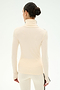 A person with dark hair styled in a bun is shown from the back against a plain white background, wearing the SPLITS59 Jackson Rib Full Length Turtleneck in Creme/Black, paired with matching pants; both pieces are crafted from soft modal blend fabric and feature long sleeves and a contemporary fit.