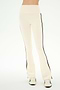 Wearing the SPLITS59 Raquel High Waist Supplex Flare pants in Creme/Black—featuring a cream color, high waist, black side stripes, and 4-way stretch Supplex fabric ideal for workouts—and white sneakers with black accents, this person stands against a plain light background.