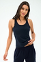Model wears the SPLITS59 Mel Airweight Lite Tank in Indigo, paired with matching pants, standing against a plain light background.