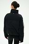 A woman with dark hair in a bun is photographed from behind against a plain white background, wearing the SPLITS59 Maeve Puffer Jacket in Black/Creme—crafted from 100% nylon—and black leggings.