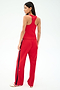 A woman faces away, wearing the SPLITS59 Mel Airweight Lite Tank in Pirate Red with matching track pants featuring a navy side stripe, paired with white sneakers.