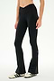 Wearing the SPLITS59 Raquel Crossover Supplex Flare in Black—high-waisted, flared leggings crafted from 4-way stretch Supplex—a person stands against a plain white background in white sneakers with black stripes. Perfect for yoga, these crossover waist leggings deliver both comfort and style.