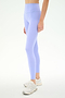 Model wearing SPLITS59 Airweight High Waist 26" leggings in Purple Haze and white athletic shoes, against a plain white background. Only the lower torso and legs are visible.