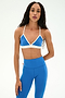 A person wearing the SPLITS59 Sage Rigor Bra in Classic Blue/White with matching blue leggings, perfect for Pilates, stands against a plain white background.