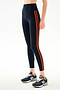 SPLITS59 Ella High Waist Airweight 7/8 - Indigo/Valencia high-waisted spandex leggings with two vertical orange stripes, worn with blue and grey athletic sneakers.