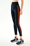 SPLITS59 Ella High Waist Airweight 7/8 - Indigo/Valencia high-waisted spandex leggings with two vertical orange stripes, worn with blue and grey athletic sneakers.