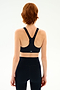 Back view of a person wearing an Indigo/Valencia Ella Airweight Bra with “S59” printed on the racerback band, paired with matching high-waisted leggings.
