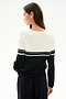 Woman facing away from the camera, wearing the SPLITS59 Anna Knit Pullover - Black/White and black pants against a plain white background.