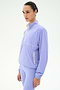 A person wearing the SPLITS59 Lyle Woven Nylon Pullover in Purple Haze/Creme stands against a plain white background, looking forward.