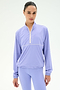 A woman wears the SPLITS59 Lyle Woven Nylon Pullover in Purple Haze/Creme, standing against a plain white background.