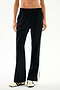 Black wide-leg Maxie Rigor Track Pant - Black/White with a white side stripe, worn with black and white sneakers.