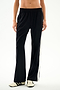 Black wide-leg Maxie Rigor Track Pant - Black/White with a white side stripe, worn with black and white sneakers.