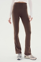 A person wearing SPLITS59 Raquel High Waist Flared Legging in Dark Chocolate with White side stripes, made from 4-way stretch supplex fabric, and running shoes is standing against a white background. Only the lower torso and legs are visible.