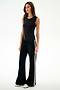 A woman wears the SPLITS59 Nikki Jersey Tank - Black with black flared viscose pants featuring white side stripes and white shoes, standing against a plain white background.
