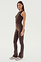 A woman stands in a side pose wearing the SPLITS59 Raquel High Waist Flared Legging in Dark Chocolate with a matching athletic top and light-colored sneakers against a plain white background.