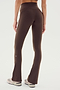 Model wears SPLITS59 Raquel High Waist Flared Legging in Dark Chocolate, featuring 4-way stretch, paired with white sneakers. Shown from the back against a plain light background.