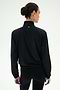 A person with dark hair in a bun is shown from the back against a plain light background, wearing the SPLITS59 Lyle Woven Nylon Pullover in Black/Creme.