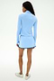 A person stands facing away on a plain white background, wearing the SPLITS59 Ozzie Rigor Skort in Skylight/Cobalt and a matching light blue long-sleeve top, paired with white sneakers—ideal for gym workouts.