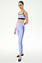 A person wears the SPLITS59 Ella High Waist Airweight 7/8 in Purple Haze/Black, paired with a matching light purple sports bra and black ballet flats, standing against a plain white background.