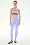 A person wears the SPLITS59 Emerson Airweight Bra in Purple Haze/Black, paired with matching high-waisted leggings, standing against a plain white background.
