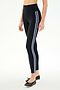 A person wears SPLITS59 Ella High Waist Airweight 7/8 leggings in Black/Purple Haze, featuring two light blue side stripes, paired with black ballet flats, standing against a plain white background.
