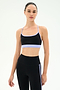 A woman models the SPLITS59 Emerson Airweight Bra in Black/Purple Haze with matching high-waisted black nylon leggings against a plain white background.