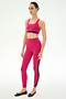 A person wears the SPLITS59 Miles Rigor Bra in Sangria/Black with matching leggings and black ballet flats, all crafted from a nylon spandex blend, standing against a plain white background.