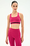 A person faces forward against a plain white background, wearing the SPLITS59 Miles Rigor Bra in Sangria/Black, styled as a matching active set.