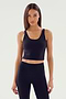 A person with long hair is wearing the Sprint Rigor Bralette in black from SPLITS59 alongside matching leggings against a plain background, showcasing multi-sport performance.
