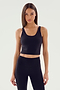 A person with long hair is wearing the Sprint Rigor Bralette in black from SPLITS59 alongside matching leggings against a plain background, showcasing multi-sport performance.