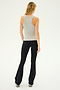 A person with long, blonde hair is standing and facing away from the camera, wearing the SPLITS59 Kiki Rib Tank Full Length in Heather Grey and black flared pants.