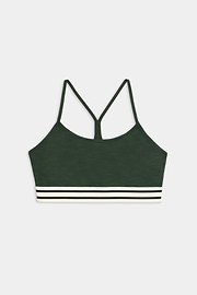 The SPLITS59 Cali Active Rib Bra is a dark green sports bra with thin straps, a racerback design, and white and black striped bands at the bottom.