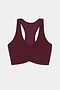 The SPLITS59 Airweight Bra With Ruching in Dark Cherry, featuring a ruched front and crafted from a soft nylon and spandex blend, is displayed flat on a white background.